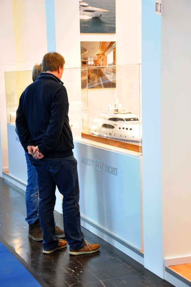 Visitors are reading a microcosm of the yacht Majesty 135 in Dusseldorf Boat Show 2014